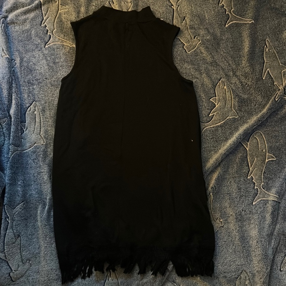 Simply Noel Black dress with tassels details at the bottom.